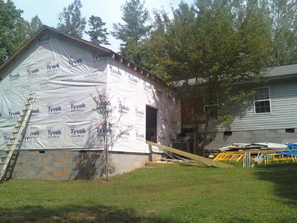 Tyvek wrapped gable on a new room addition beside an existing home in Random Lake